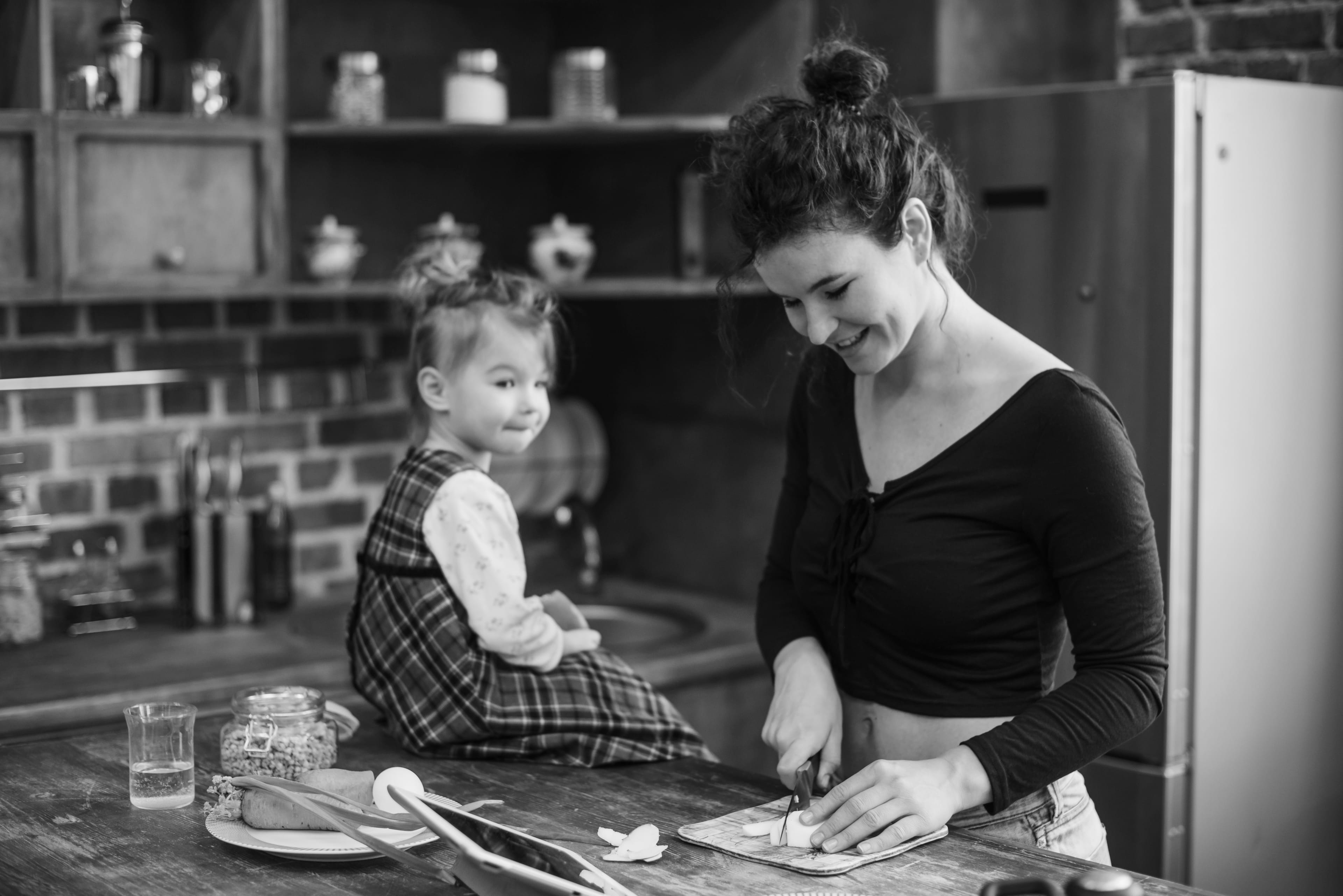 Mother and daughter cooking together in a warm kitchen